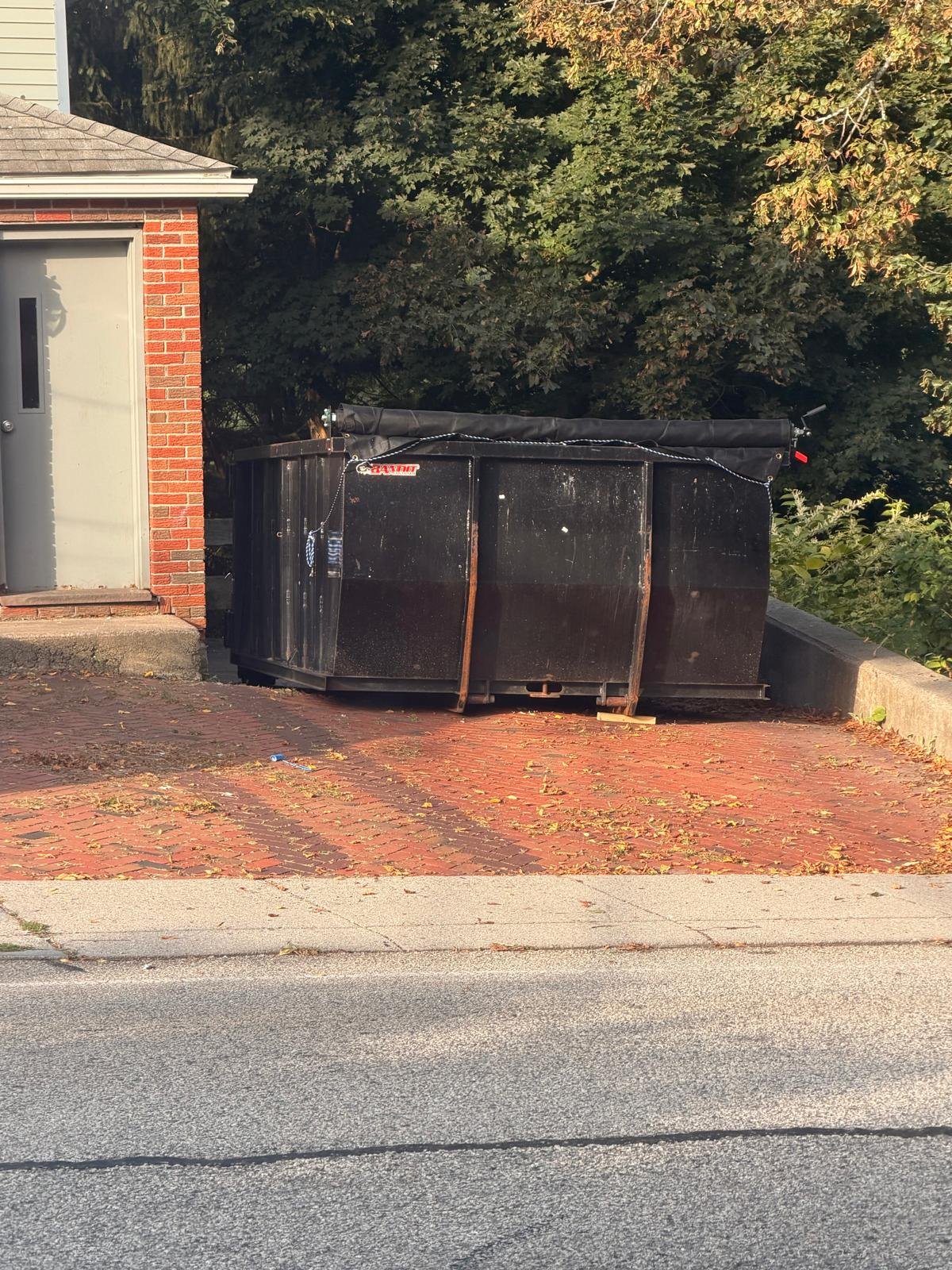 CMC Mass Hauling roll-off dumpster on a job site